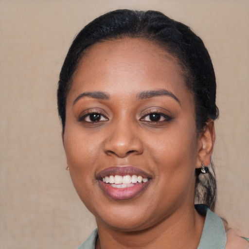 Joyful black young-adult female with medium  black hair and brown eyes