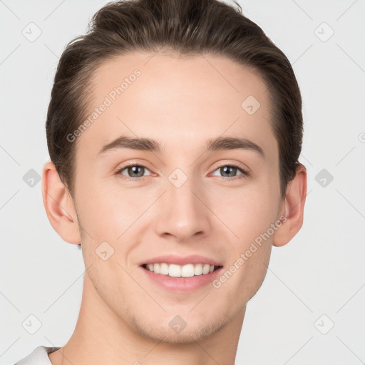 Joyful white young-adult male with short  brown hair and grey eyes