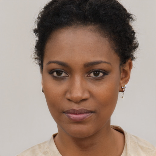 Joyful black young-adult female with short  brown hair and brown eyes