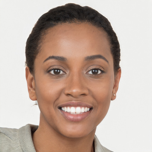 Joyful black young-adult female with short  brown hair and brown eyes