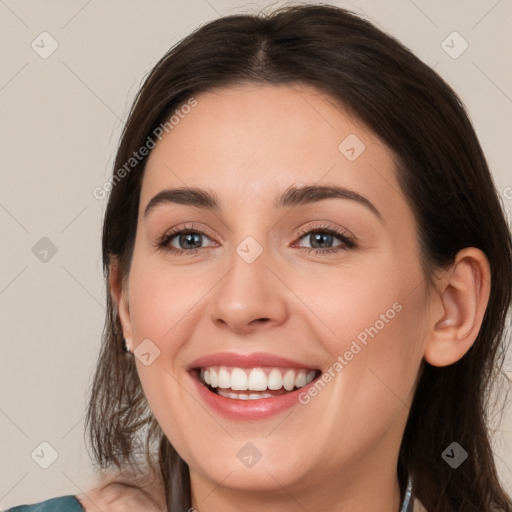 Joyful white young-adult female with medium  brown hair and grey eyes