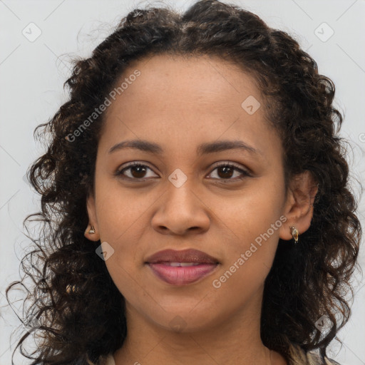 Joyful black young-adult female with long  brown hair and brown eyes