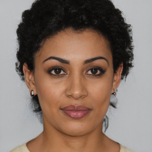 Joyful latino young-adult female with short  brown hair and brown eyes