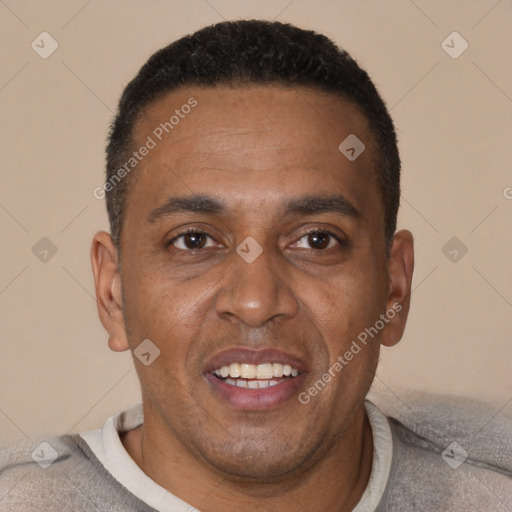 Joyful black adult male with short  brown hair and brown eyes