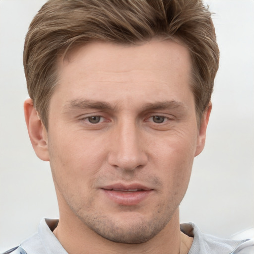 Joyful white adult male with short  brown hair and grey eyes