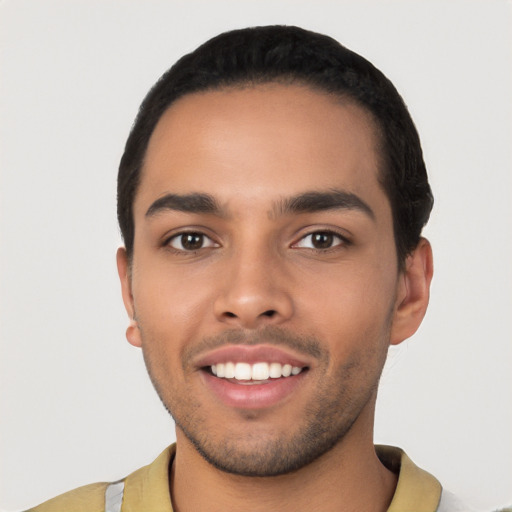 Joyful latino young-adult male with short  black hair and brown eyes