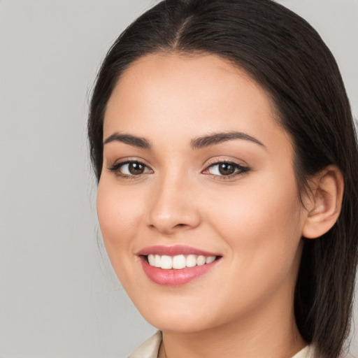 Joyful white young-adult female with long  brown hair and brown eyes