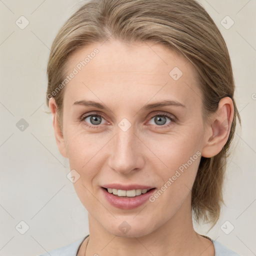 Joyful white young-adult female with medium  brown hair and blue eyes