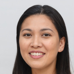 Joyful asian young-adult female with long  brown hair and brown eyes