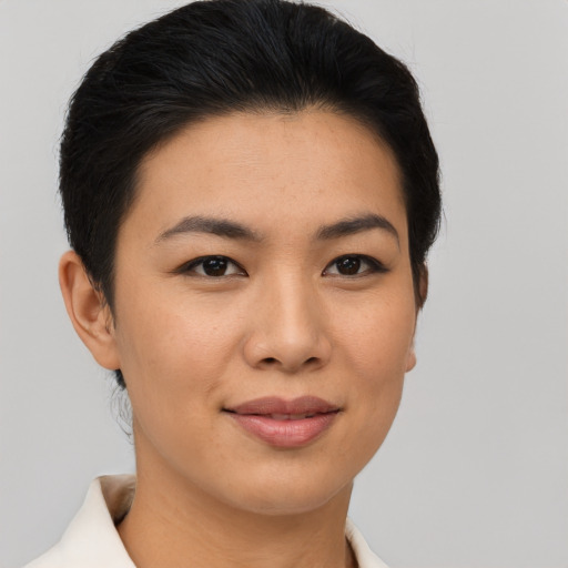 Joyful asian young-adult female with short  brown hair and brown eyes