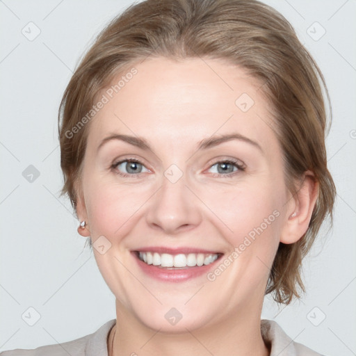 Joyful white adult female with medium  brown hair and blue eyes