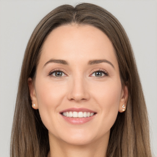 Joyful white young-adult female with long  brown hair and grey eyes