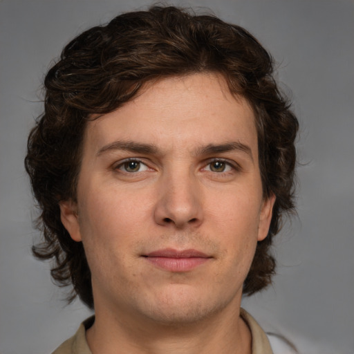 Joyful white young-adult male with medium  brown hair and brown eyes