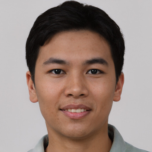 Joyful asian young-adult male with short  black hair and brown eyes