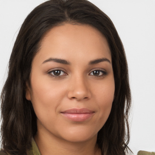 Joyful latino young-adult female with long  brown hair and brown eyes