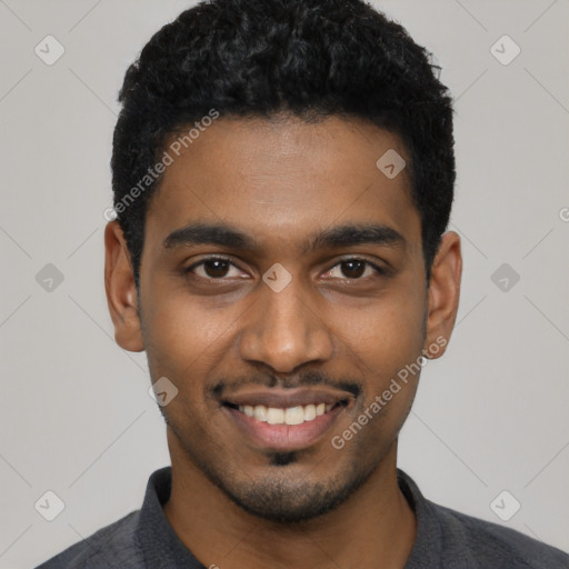 Joyful black young-adult male with short  black hair and brown eyes