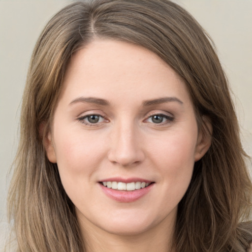 Joyful white young-adult female with long  brown hair and grey eyes