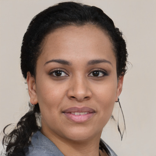 Joyful black young-adult female with short  brown hair and brown eyes