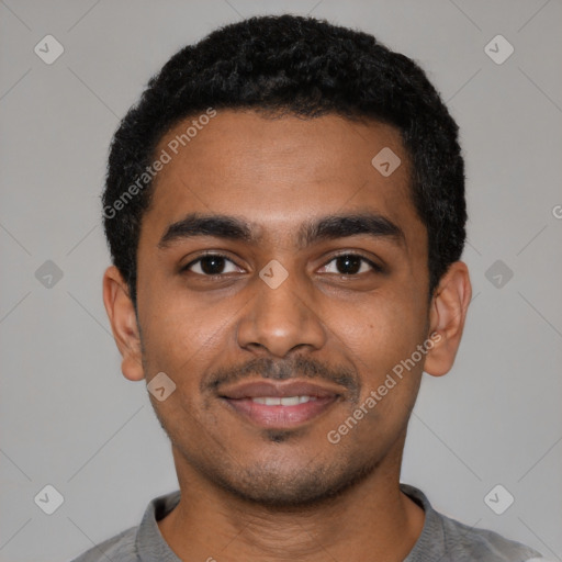 Joyful black young-adult male with short  black hair and brown eyes