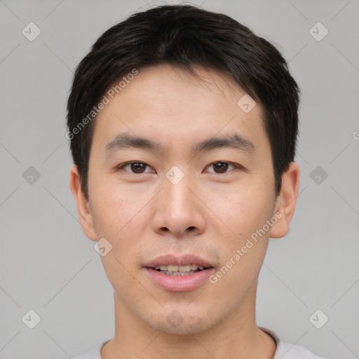 Joyful asian young-adult male with short  brown hair and brown eyes