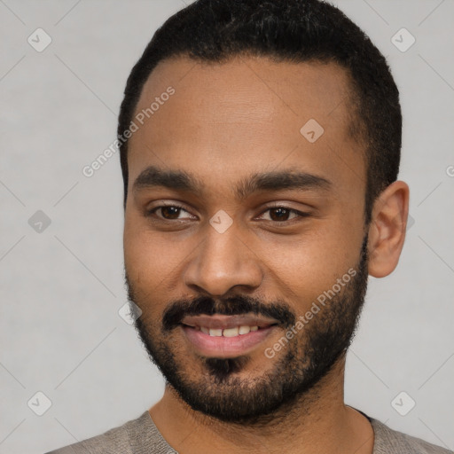 Joyful black young-adult male with short  black hair and brown eyes