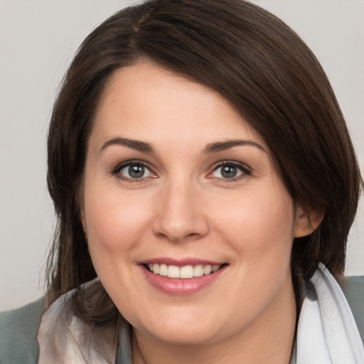 Joyful white young-adult female with medium  brown hair and brown eyes