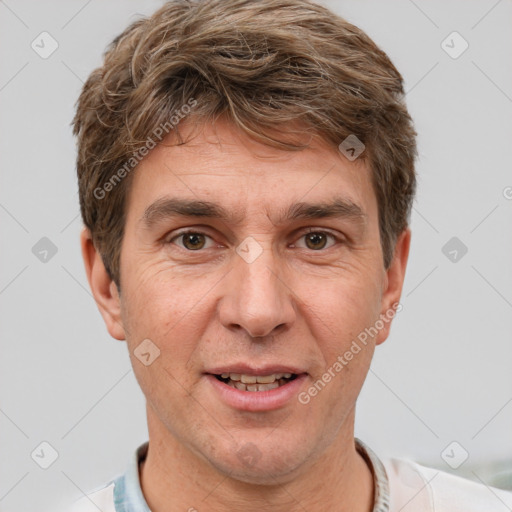 Joyful white adult male with short  brown hair and brown eyes