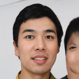 Joyful asian young-adult male with short  black hair and brown eyes