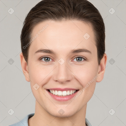 Joyful white young-adult female with short  brown hair and grey eyes