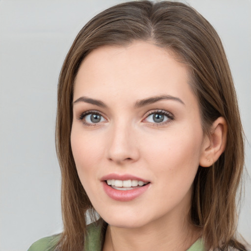 Joyful white young-adult female with long  brown hair and green eyes