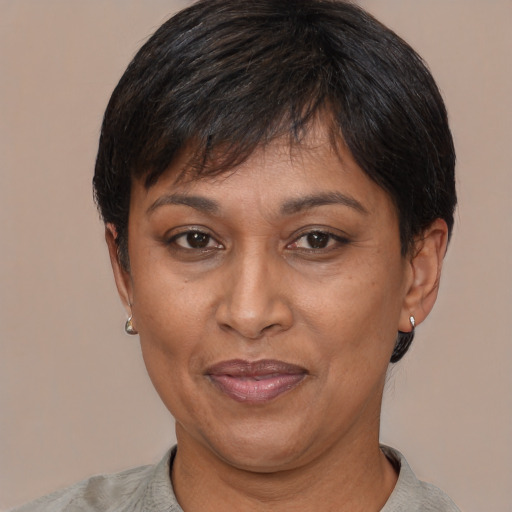 Joyful latino adult female with short  black hair and brown eyes