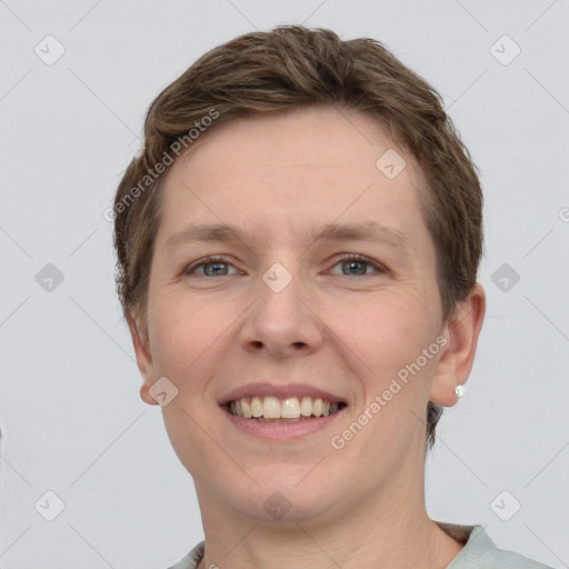 Joyful white young-adult female with short  brown hair and grey eyes