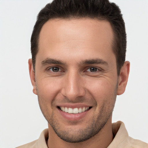 Joyful white young-adult male with short  brown hair and brown eyes