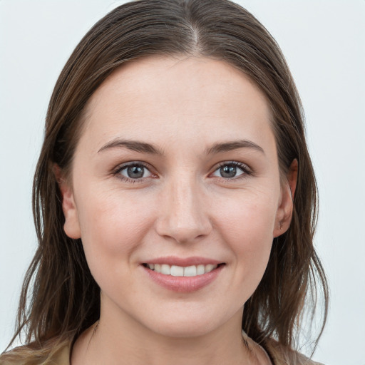 Joyful white young-adult female with long  brown hair and grey eyes