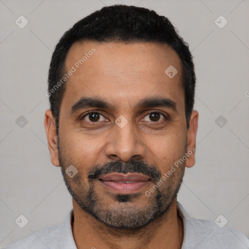 Joyful black young-adult male with short  black hair and brown eyes