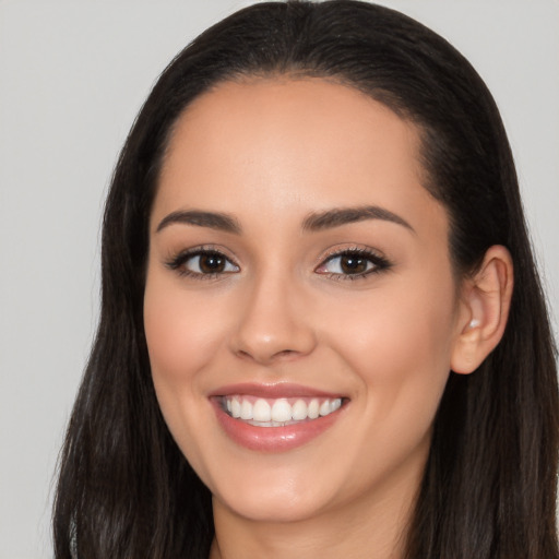 Joyful white young-adult female with long  black hair and brown eyes