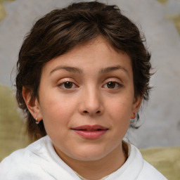 Joyful white child female with medium  brown hair and brown eyes