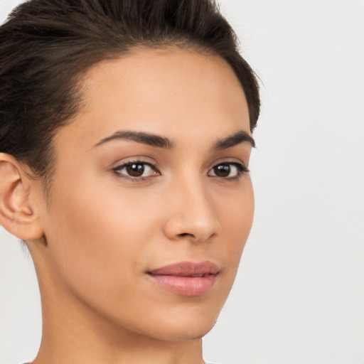 Joyful latino young-adult female with short  brown hair and brown eyes