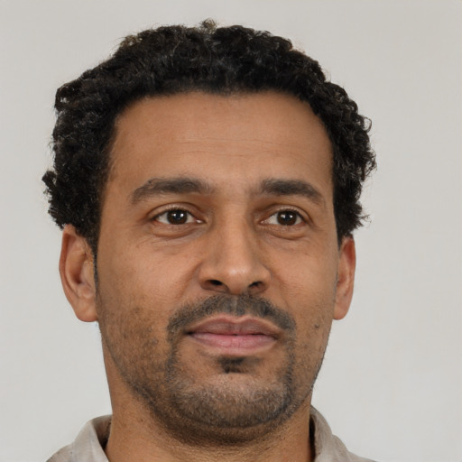 Neutral latino adult male with short  black hair and brown eyes