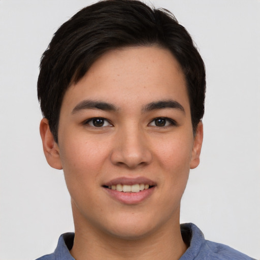 Joyful asian young-adult male with short  brown hair and brown eyes