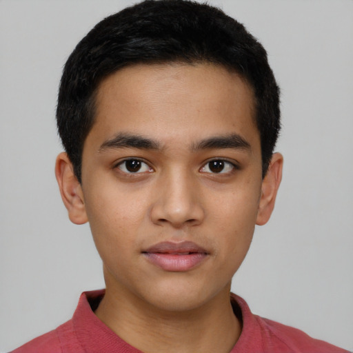 Joyful latino young-adult male with short  brown hair and brown eyes