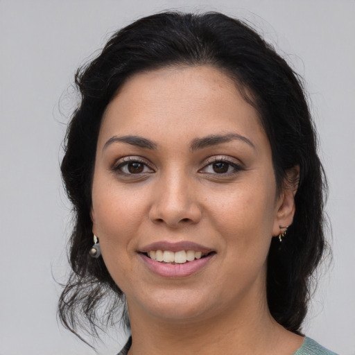 Joyful latino young-adult female with medium  brown hair and brown eyes