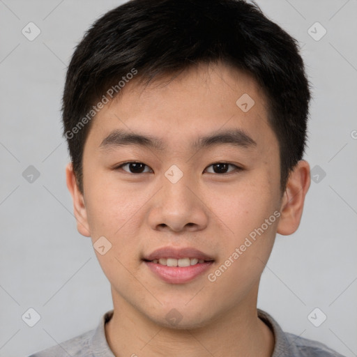 Joyful asian young-adult male with short  brown hair and brown eyes