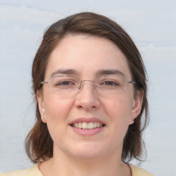 Joyful white adult female with medium  brown hair and grey eyes