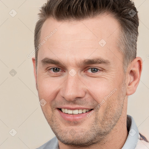 Joyful white adult male with short  brown hair and brown eyes