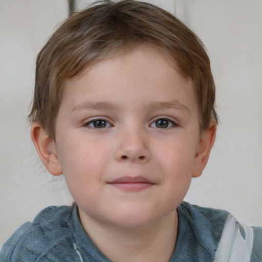 Joyful white child male with short  brown hair and blue eyes