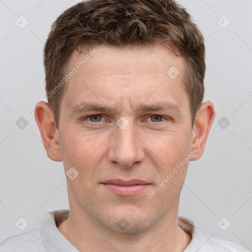 Joyful white adult male with short  brown hair and grey eyes