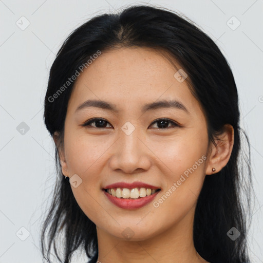 Joyful asian young-adult female with long  brown hair and brown eyes