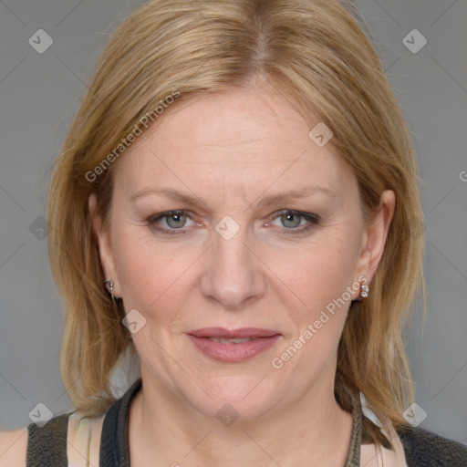 Joyful white adult female with medium  brown hair and blue eyes