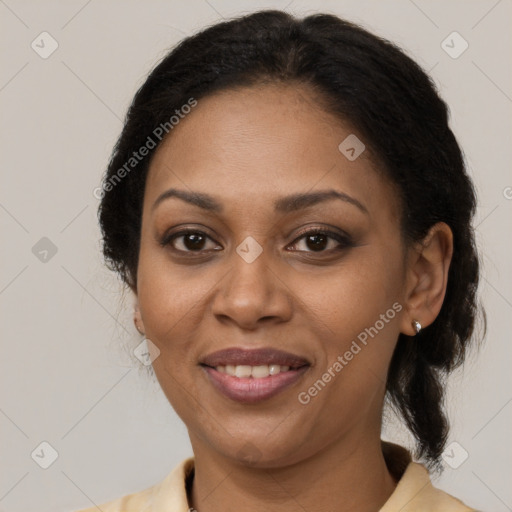 Joyful black adult female with medium  brown hair and brown eyes